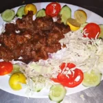 Beef Bihari kabab served with salad, lemon and cucumber