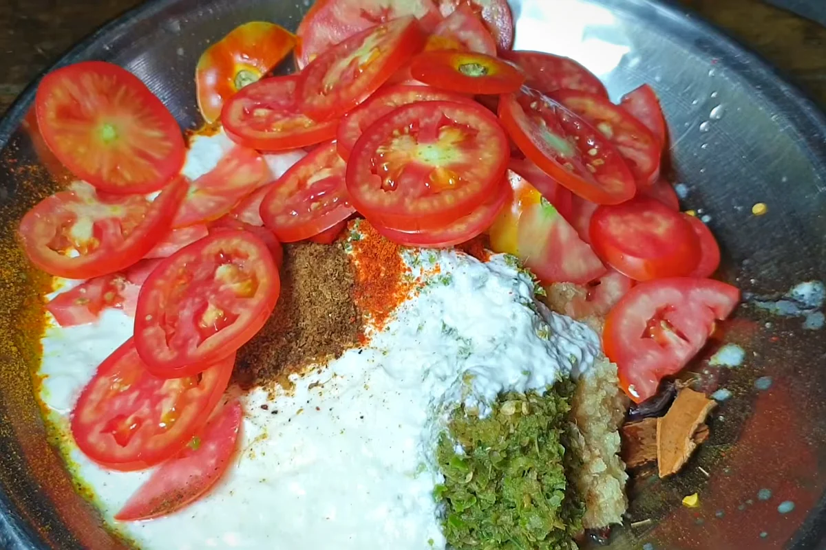 Yogurt, green chilli paste, red chilli powder, garam masala and sliced tomatoes added to the biryani masala tray