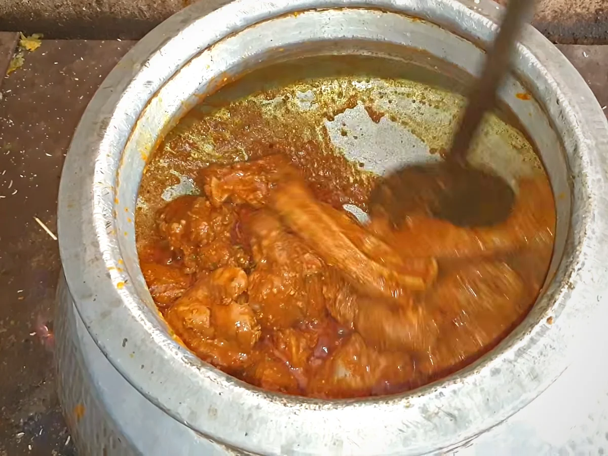 Beef korma cooking in a large deg for haleem