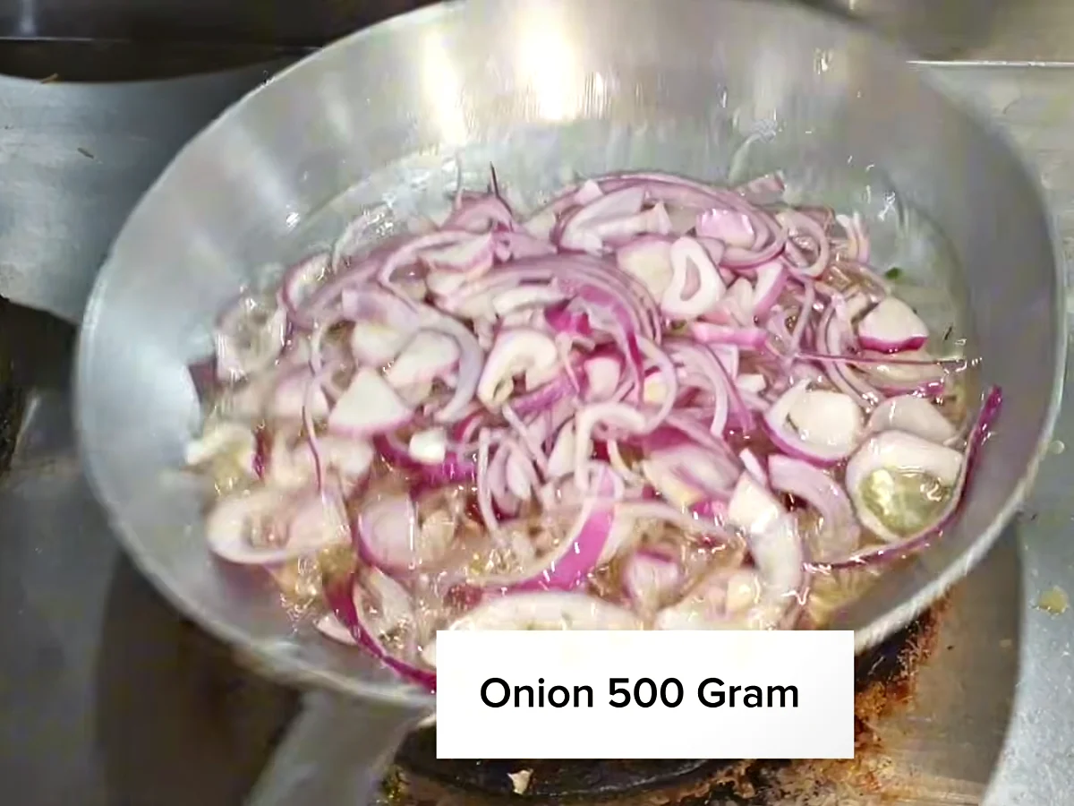 500 g sliced onion in a pan for beef bihari boti marinade