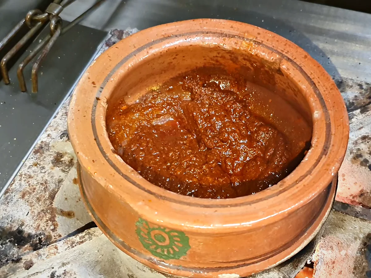 Boiled dal added to the tomato masala in a handi