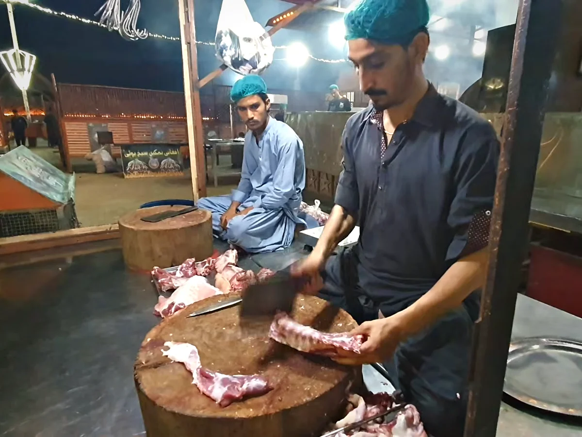 Butcher cutting mutton rib chops at Dua Restaurant