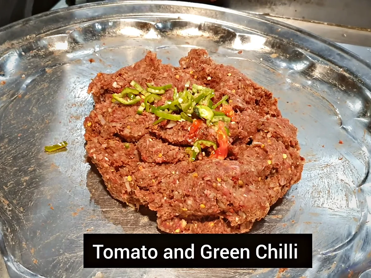 Chopped tomato and green chilli added to chapli kabab mixture