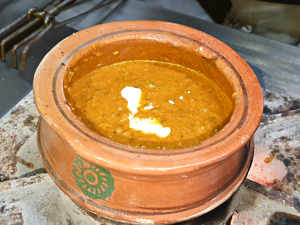 Cream being added to dal makhani handi