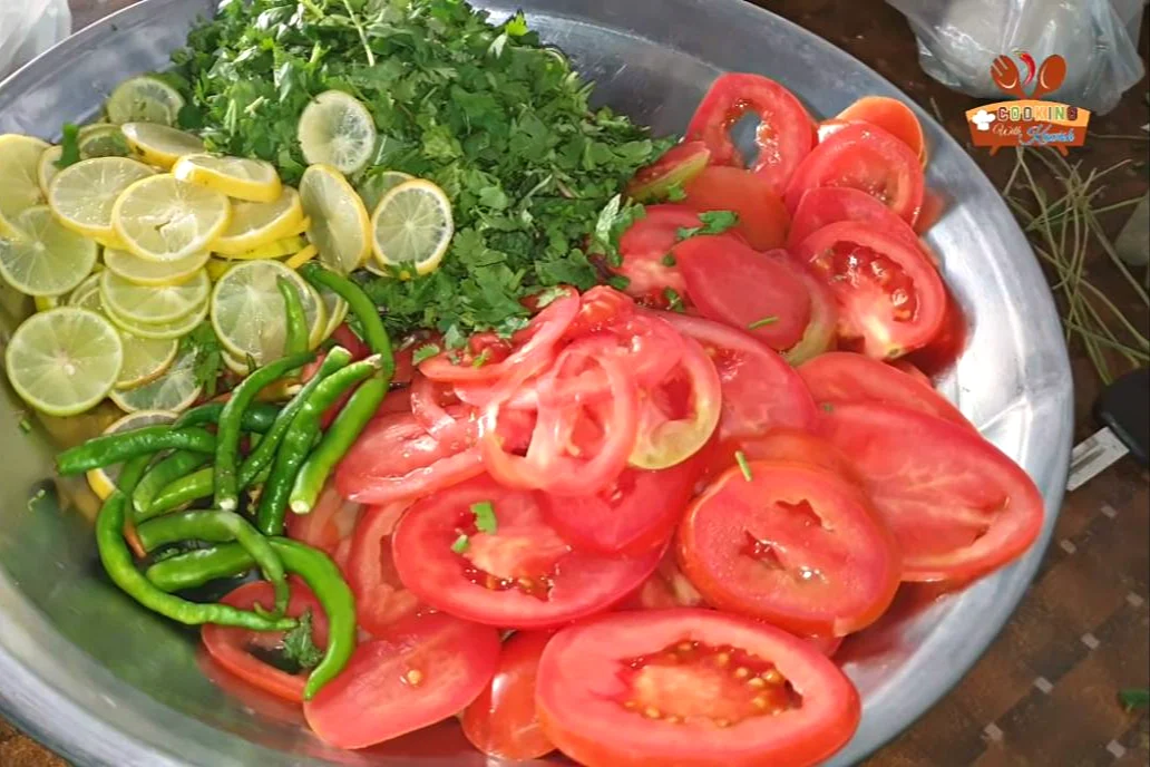 Sliced tomatoes, lemon slices, mint, coriander and green chillies for the biryani layer