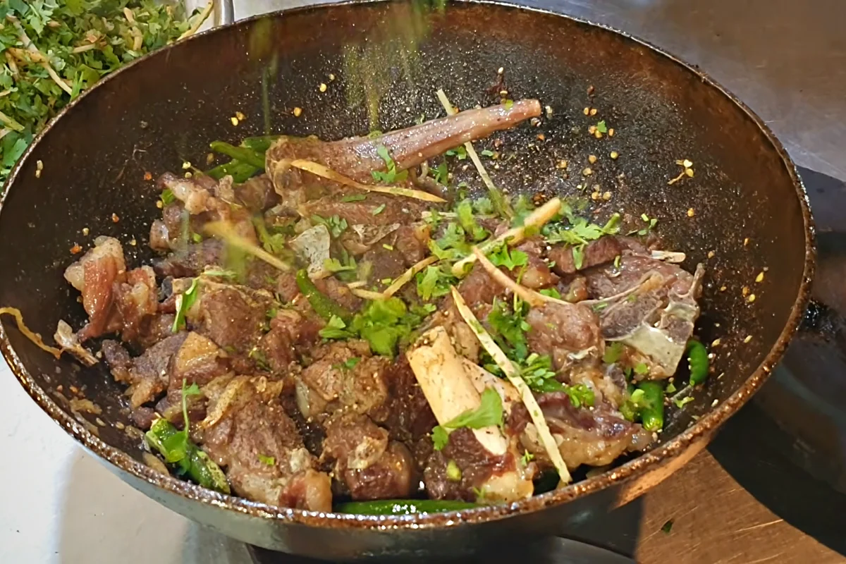 Ginger and coriander scattered over sulemani mutton karahi