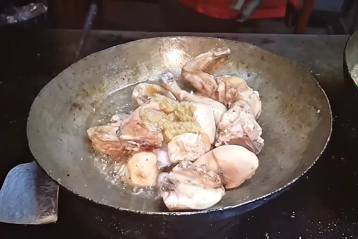 Ginger garlic paste stirred into fried chicken for karahi