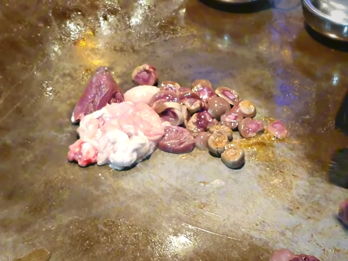 Chopped goat heart and kidneys on a hot tawa for kata kat