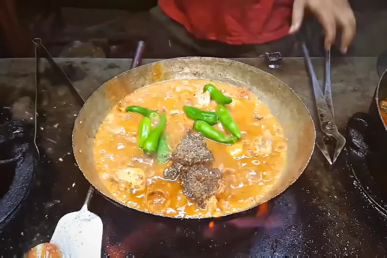 Whole green chillies added to chicken karahi with spices