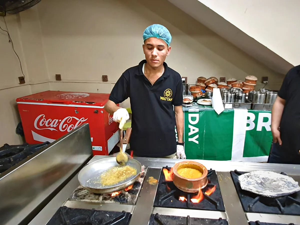 Cook at Watan Restaurant making dal makhani handi and tadka