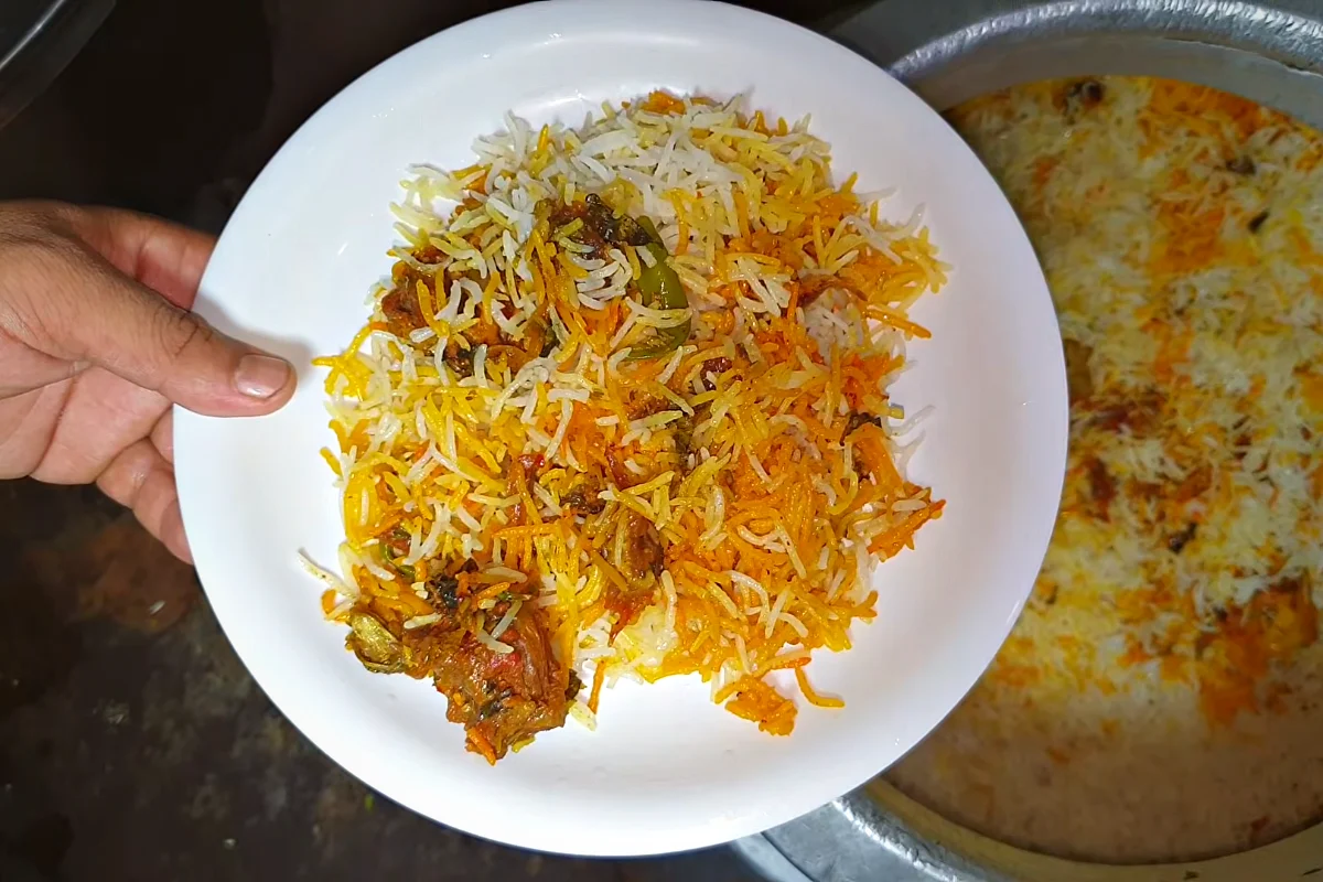 Plate of Karachi raseeli beef biryani with yellow and white rice, beef and potato