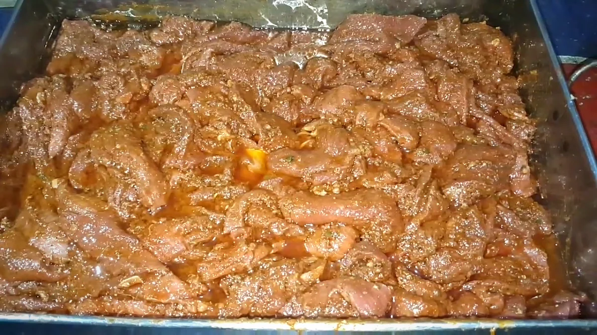 Beef strips fully coated in Bihari kabab marinade