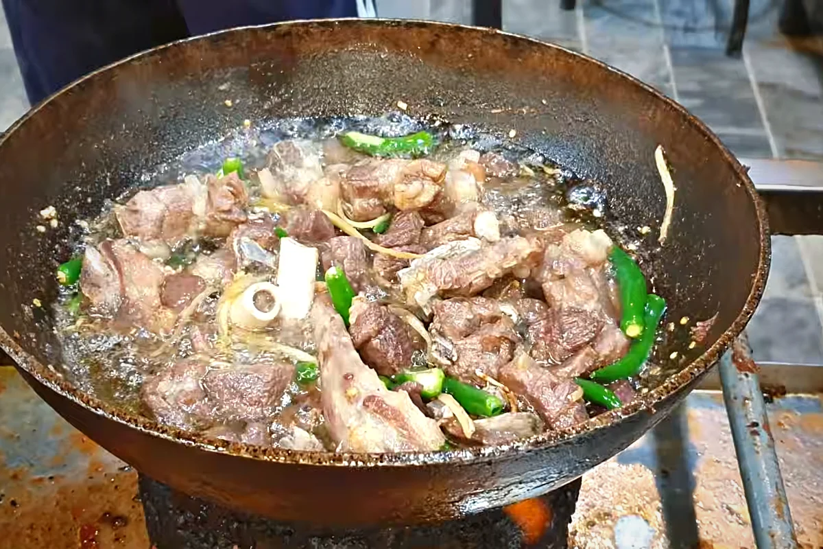 Medium green chillies added to sulemani mutton karahi