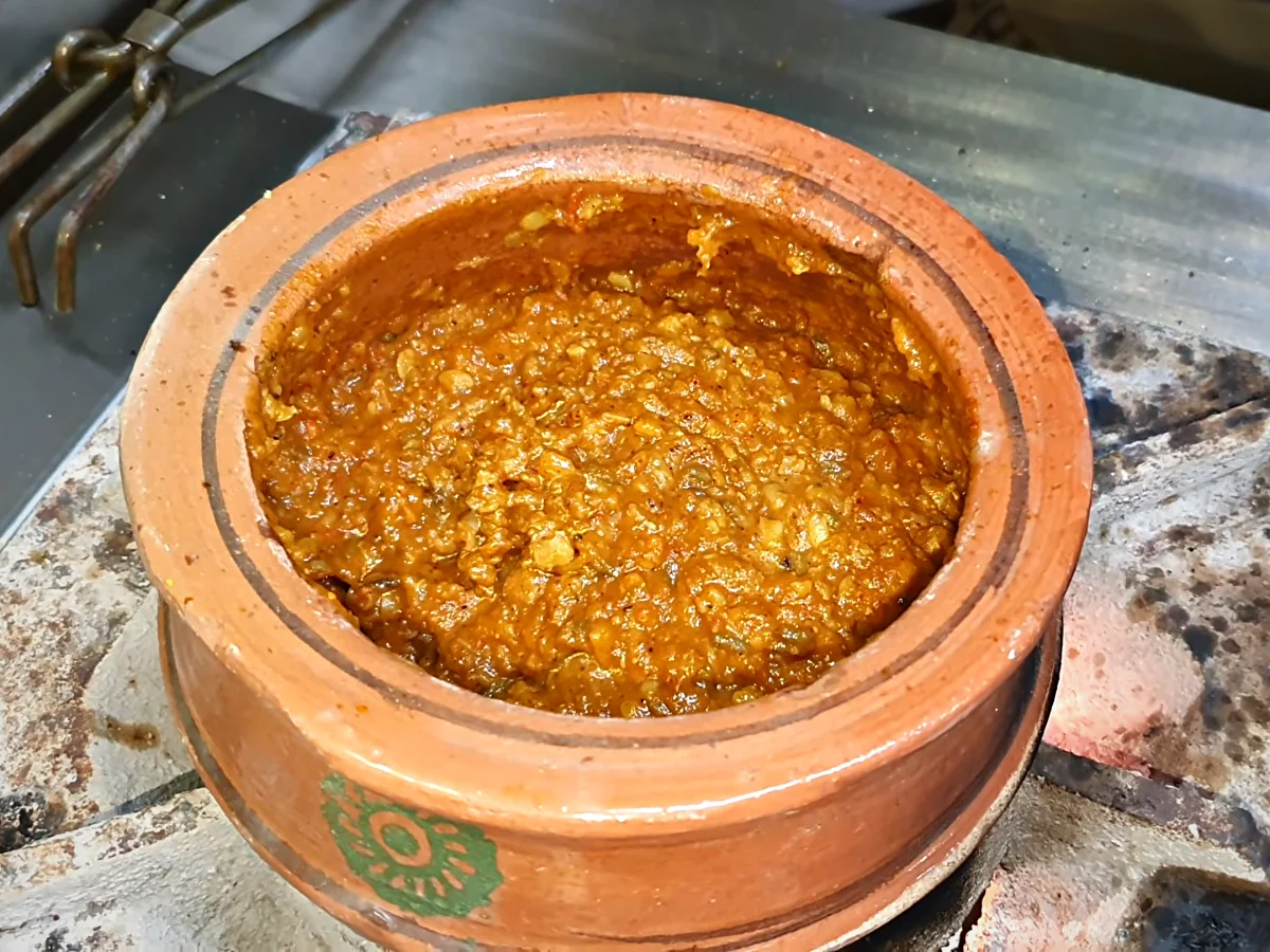 Milk being added to dal makhani in a handi