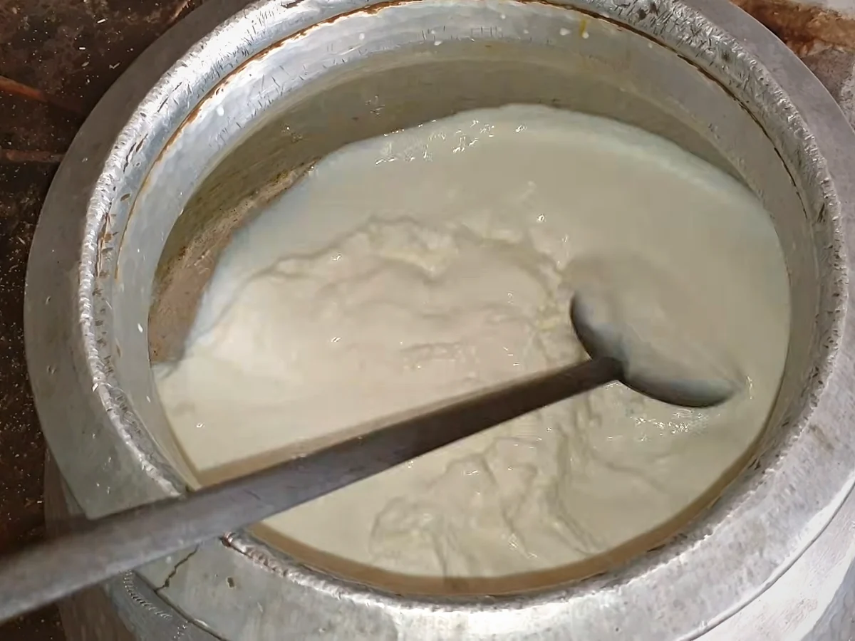 Milk coming to a boil in a large pot for doodh dulari
