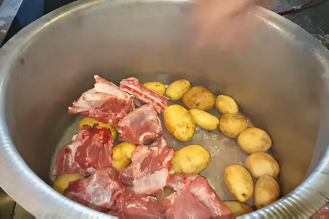 Large mutton pieces layered over potatoes for mutton rosh
