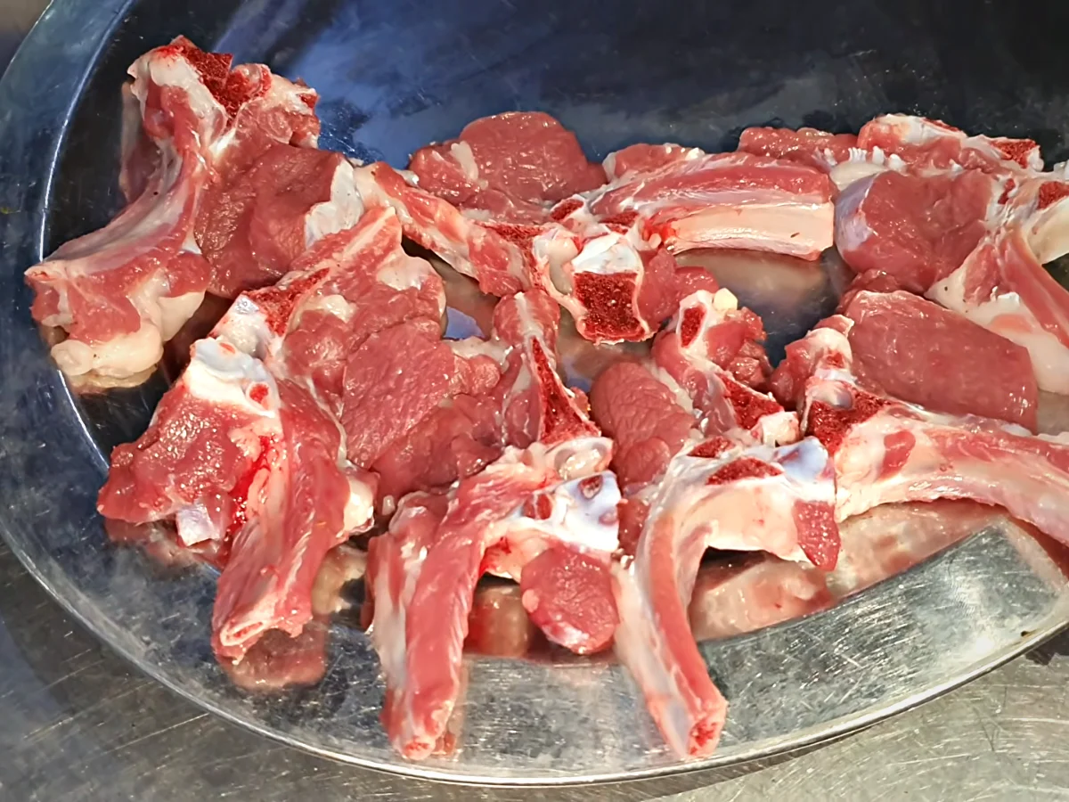 Raw mutton rib chops on a tray before marinating