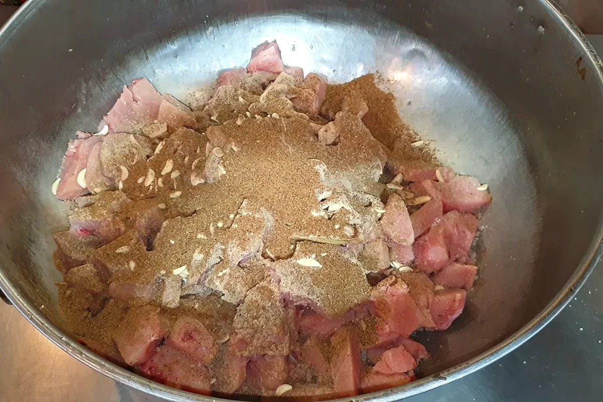 Black pepper, white and brown spice powders over chicken for reshmi kabab