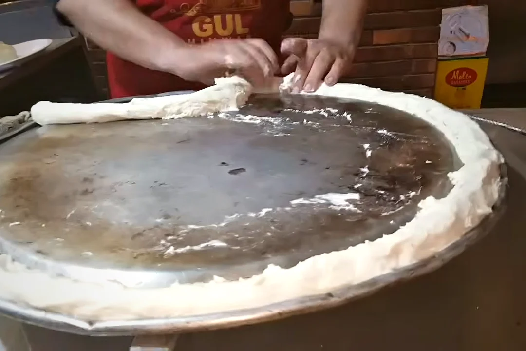 Sealing the lid of the mutton rosh pot with a rope of dough