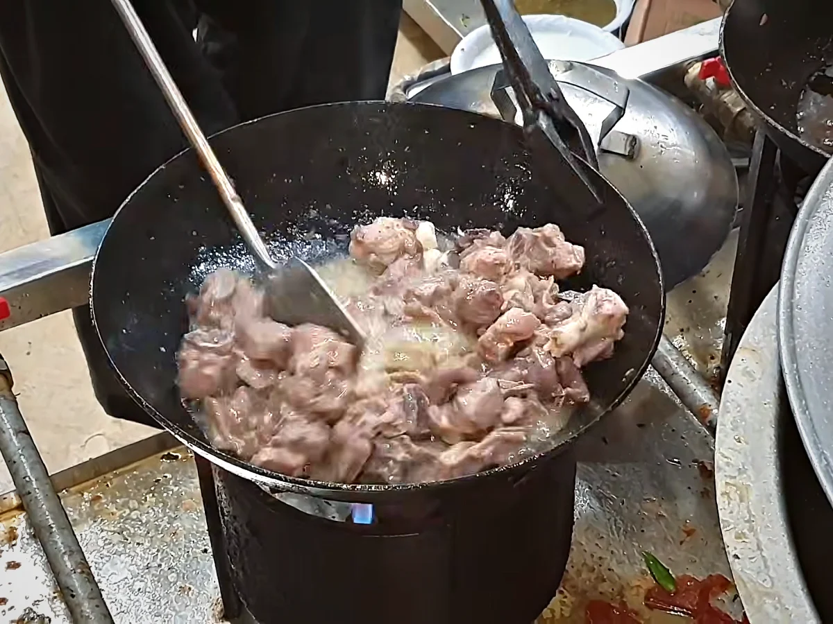 Tender mutton frying in oil after the water has dried