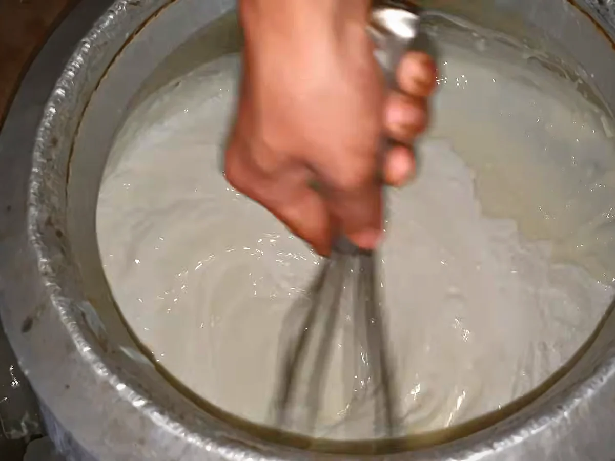 Cream being whisked into cooled doodh dulari