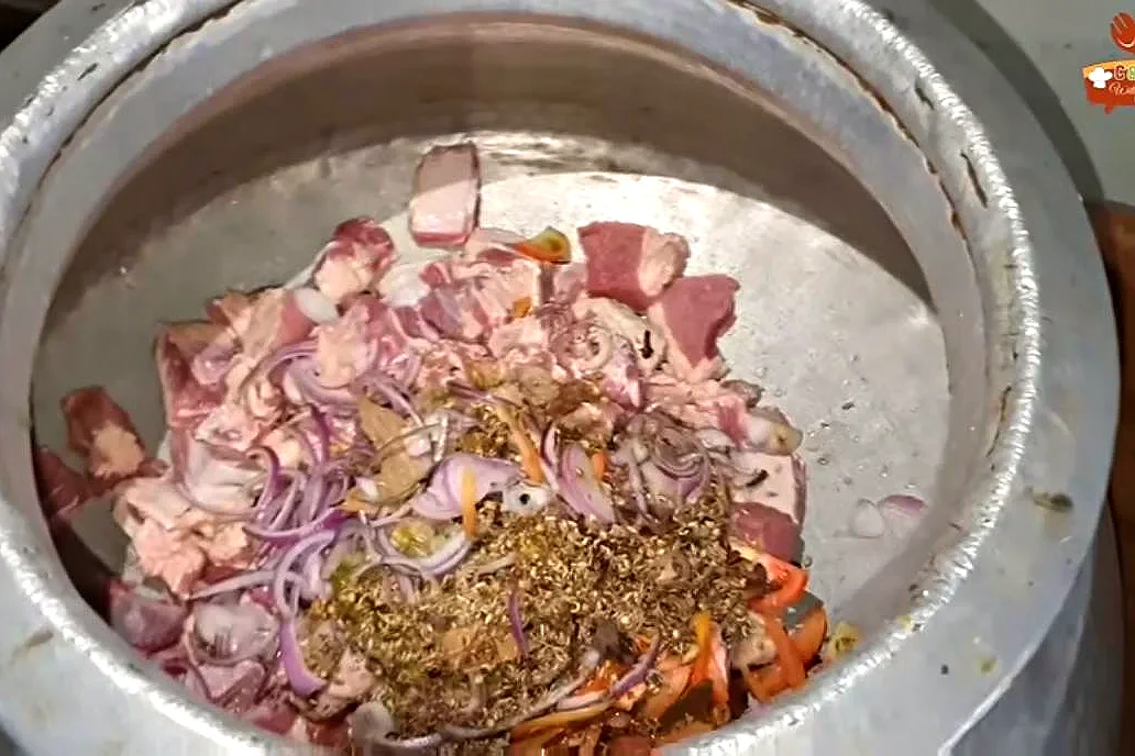 4 kg beef with onion and whole spices in a large aluminium deg
