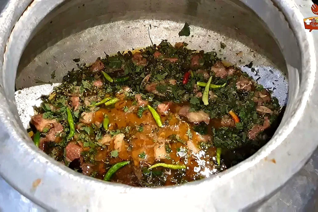 Mint, coriander and whole green chillies layered over the cooked beef for white biryani