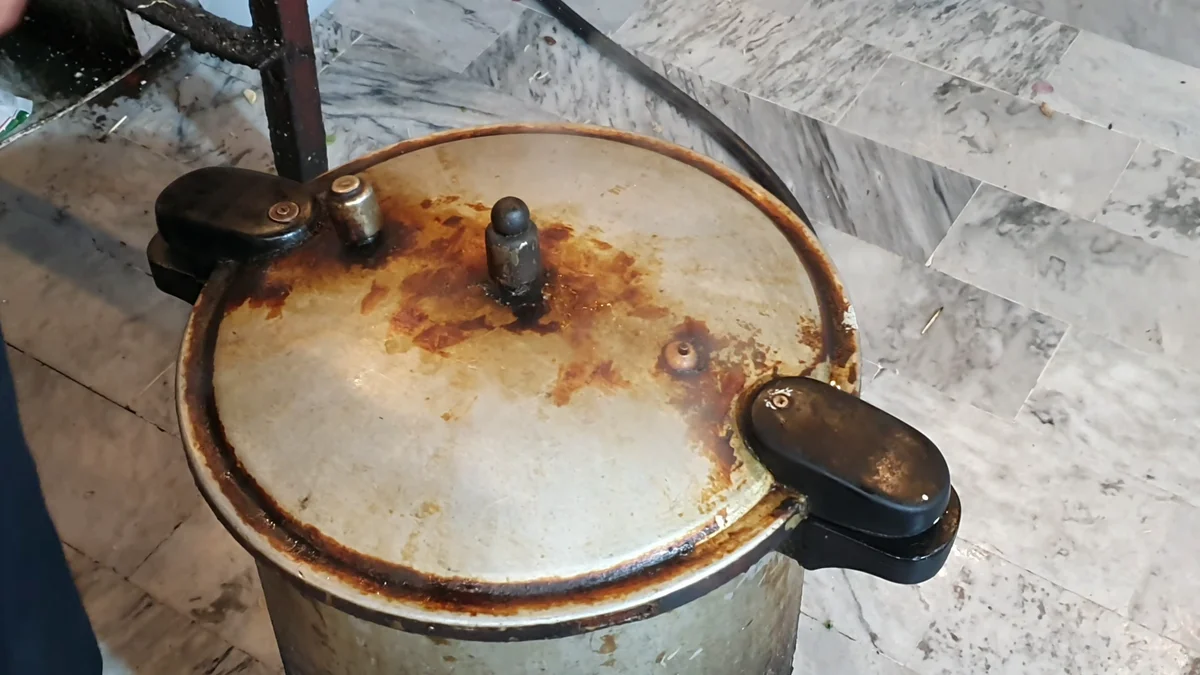 Closed pressure cooker on the flame while the mutton cooks
