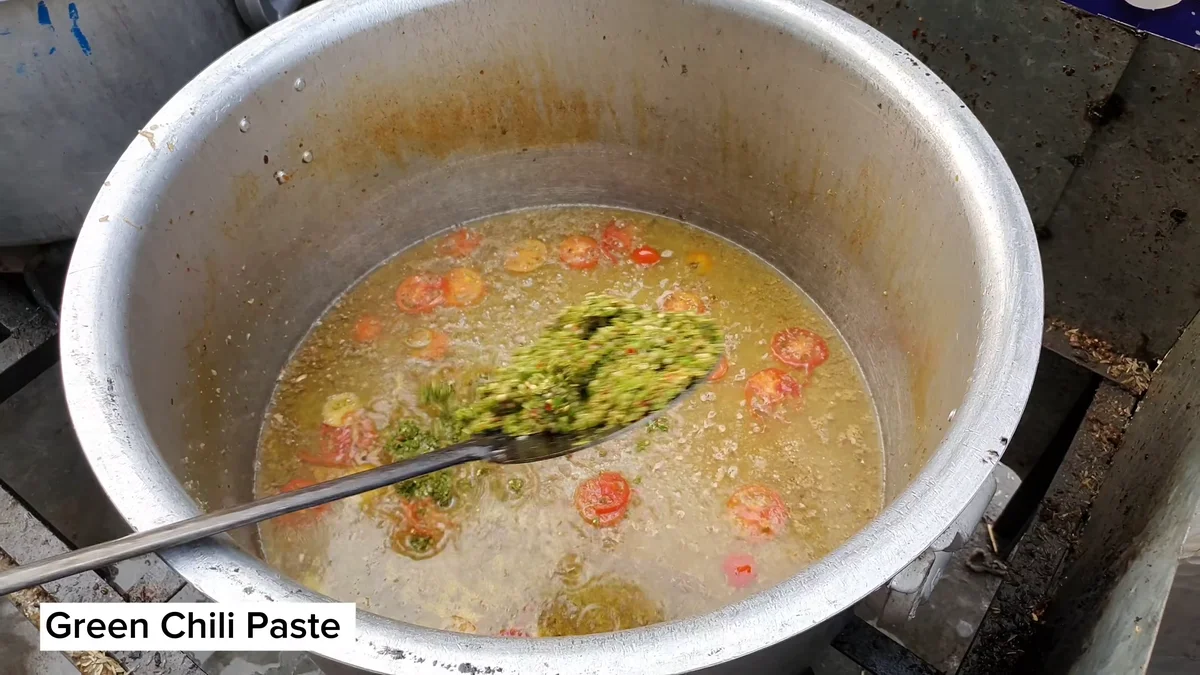 Green chilli paste added to the masala in the pot