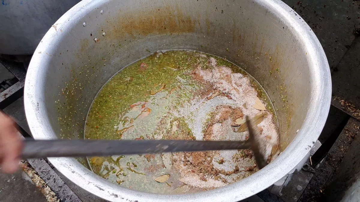 Boiled beef pieces going into the pulao pot