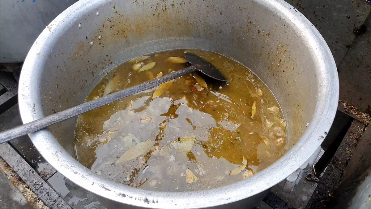 Golden beef yakhni in the pot before the rice goes in