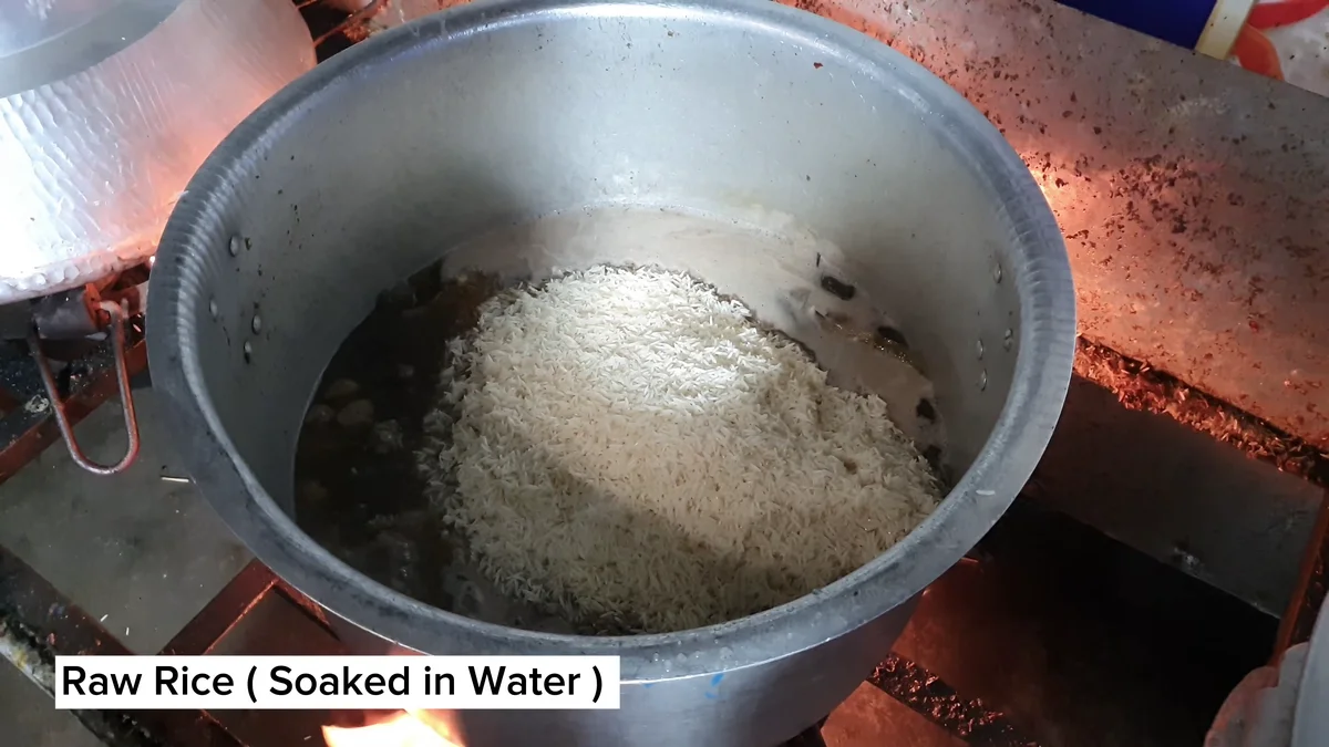 Soaked raw rice going into the pot