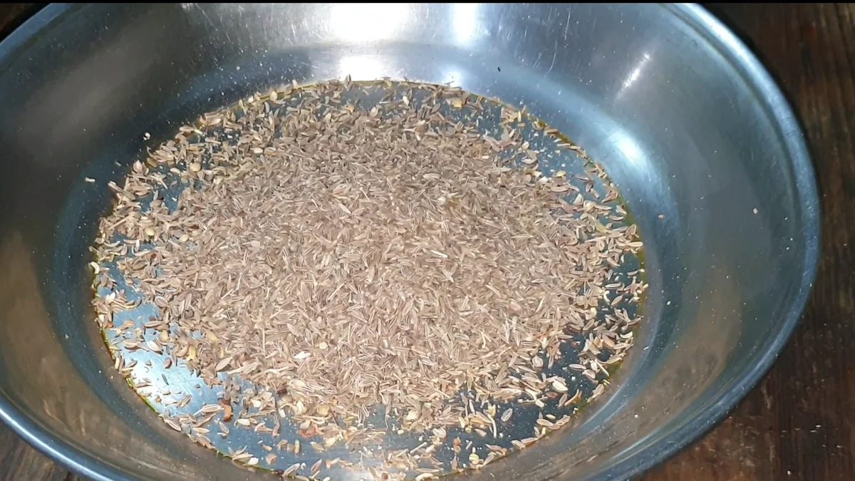 Crushed whole spices in a steel bowl for the pulao