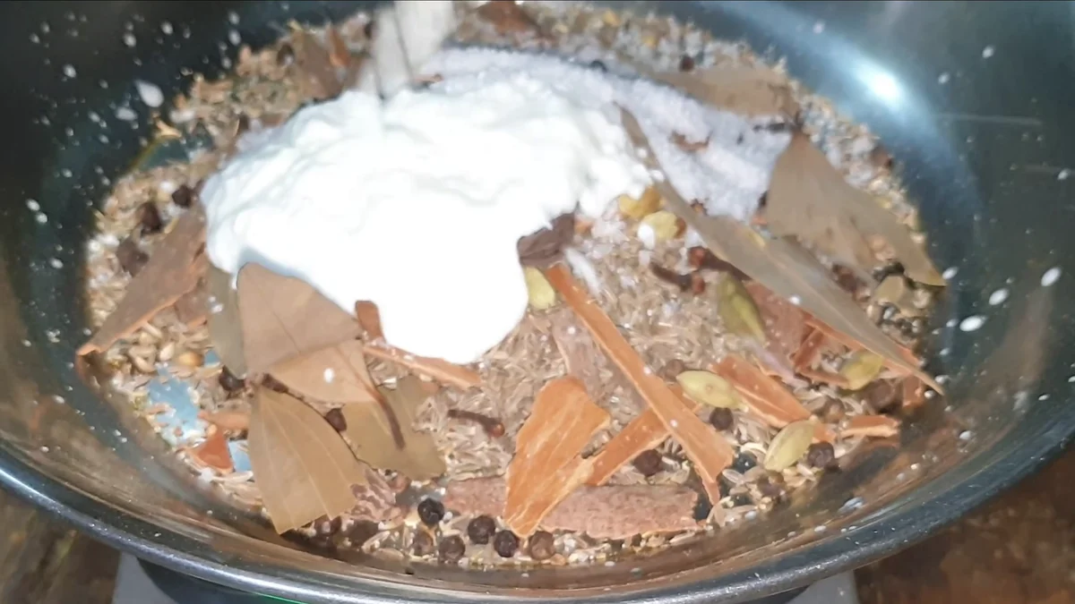 Yogurt added to the spice mix in the bowl