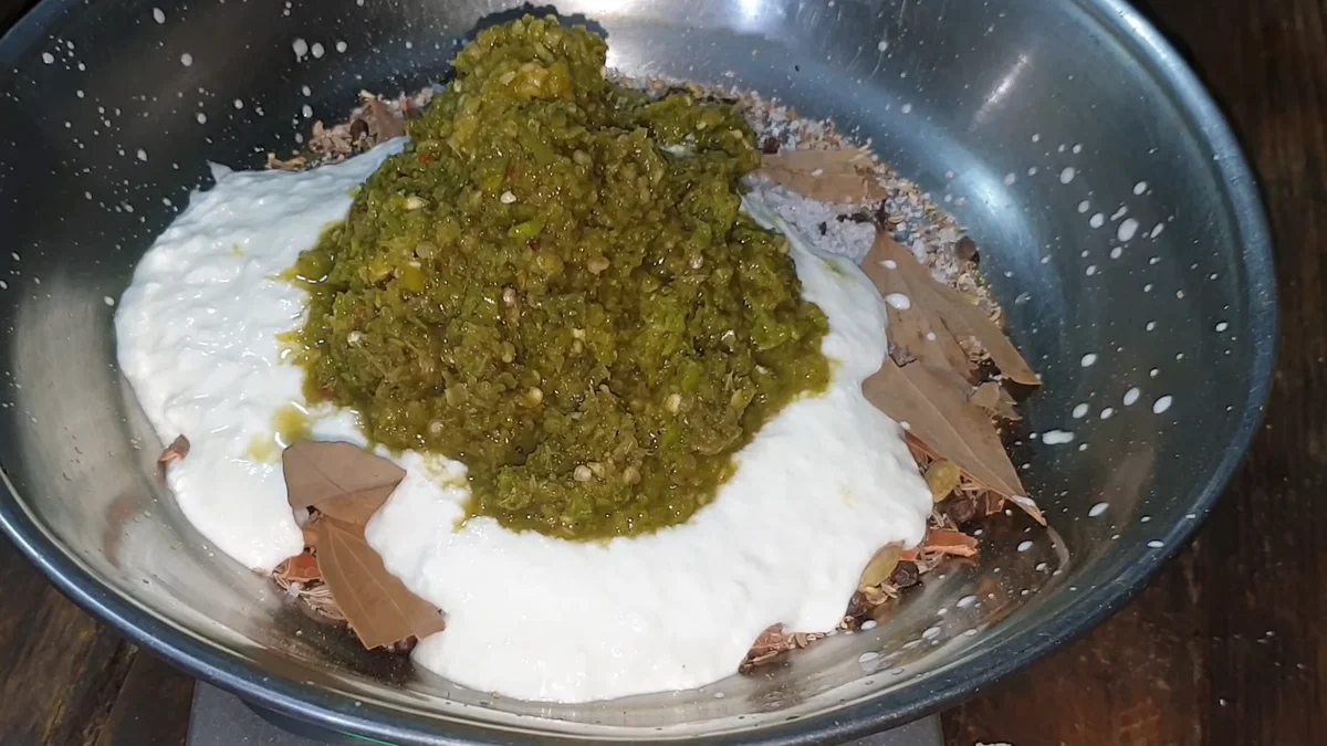 Green chilli paste added over the yogurt