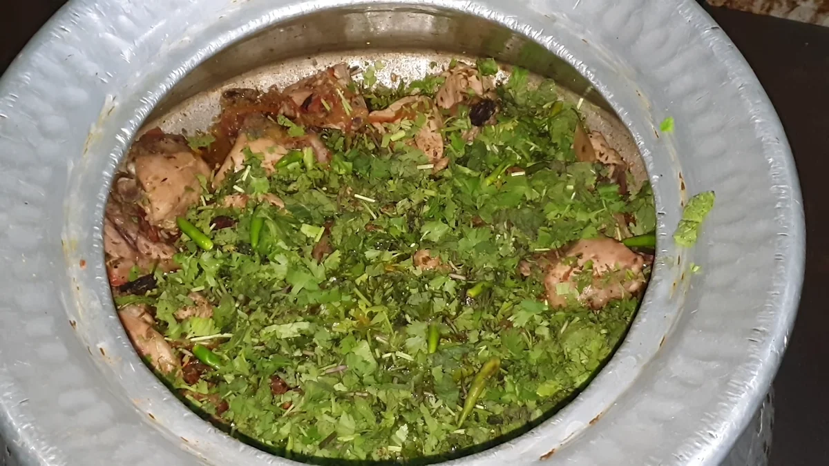 Mint, coriander and green chillies spread over the chicken layer
