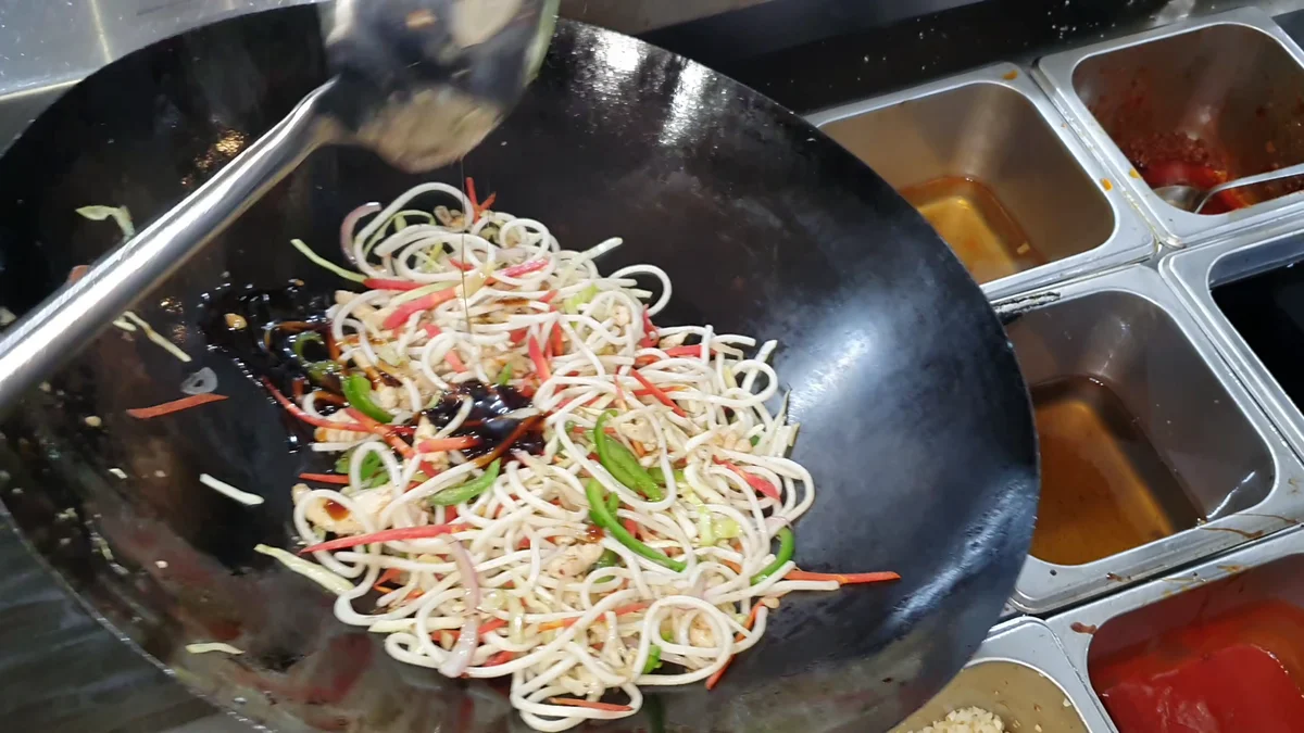 Sauces and chilli oil added over the noodles
