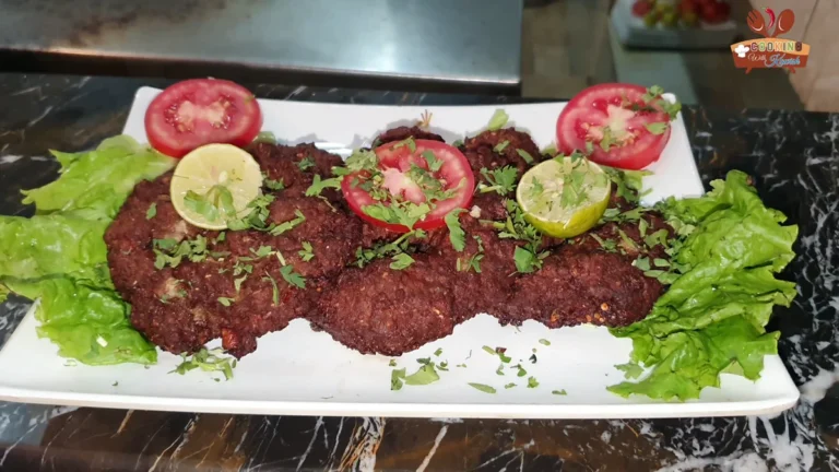 Khan Jee beef chapli kababs on a platter with lettuce, tomato and lemon