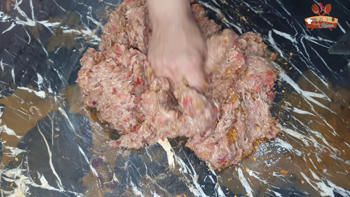 Kneading the chapli kabab mixture by hand