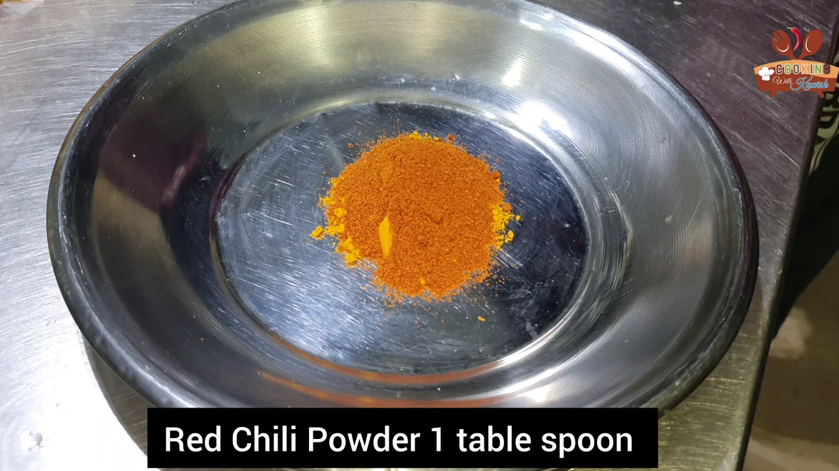Red chilli powder, one tablespoon, on a steel tray