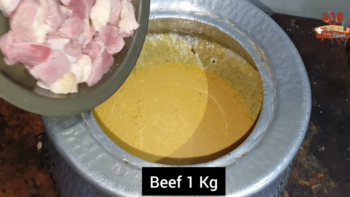 One kilo of beef being added to the yogurt masala