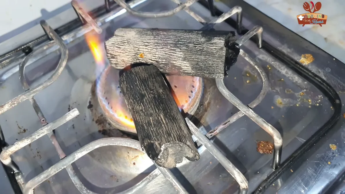 Charcoal pieces heating on the stove flame