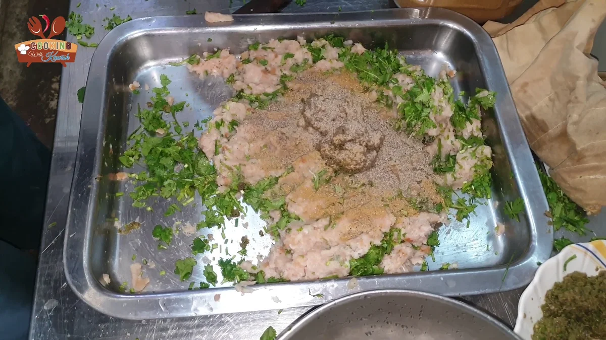 Ground spices piled on the chicken mince