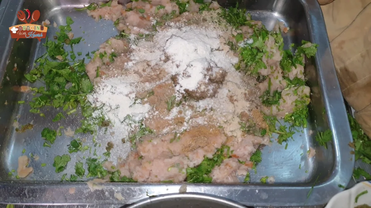 White powder being added to the cutlet mixture