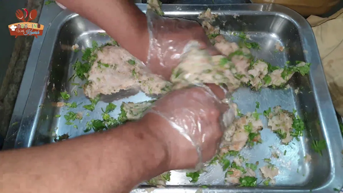 Mixing the chicken cutlet mixture by hand