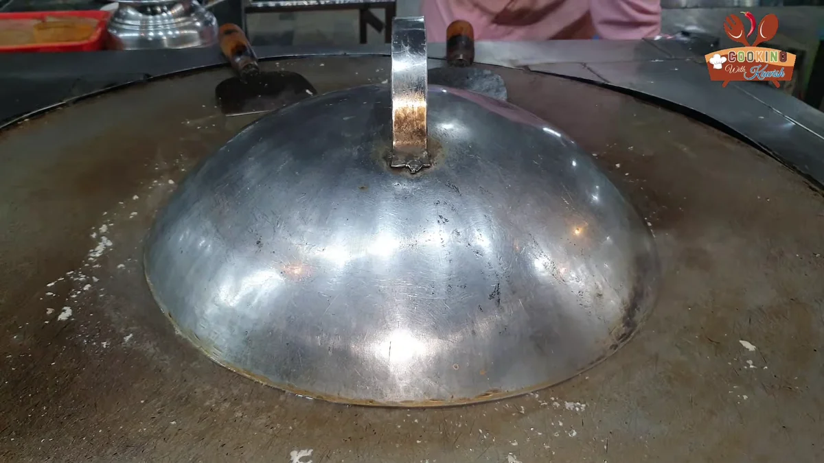 Lid covering the brain and tomatoes on the tawa