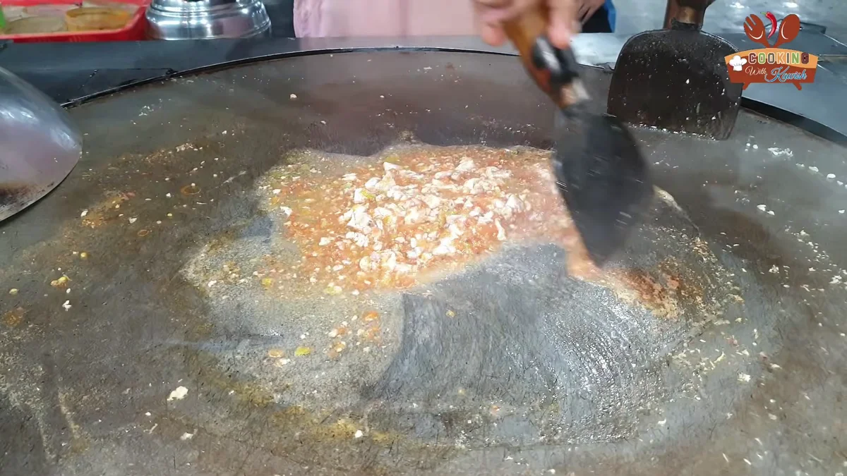 Brain being mashed into the masala on the tawa
