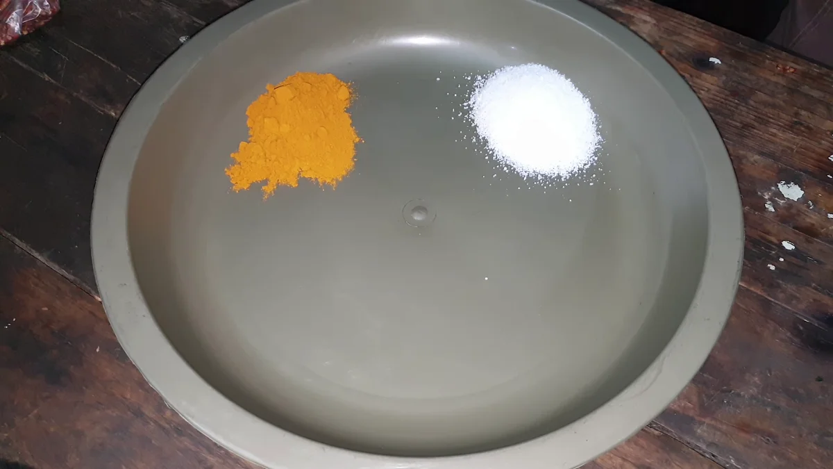 Turmeric and salt on a steel plate for the biryani