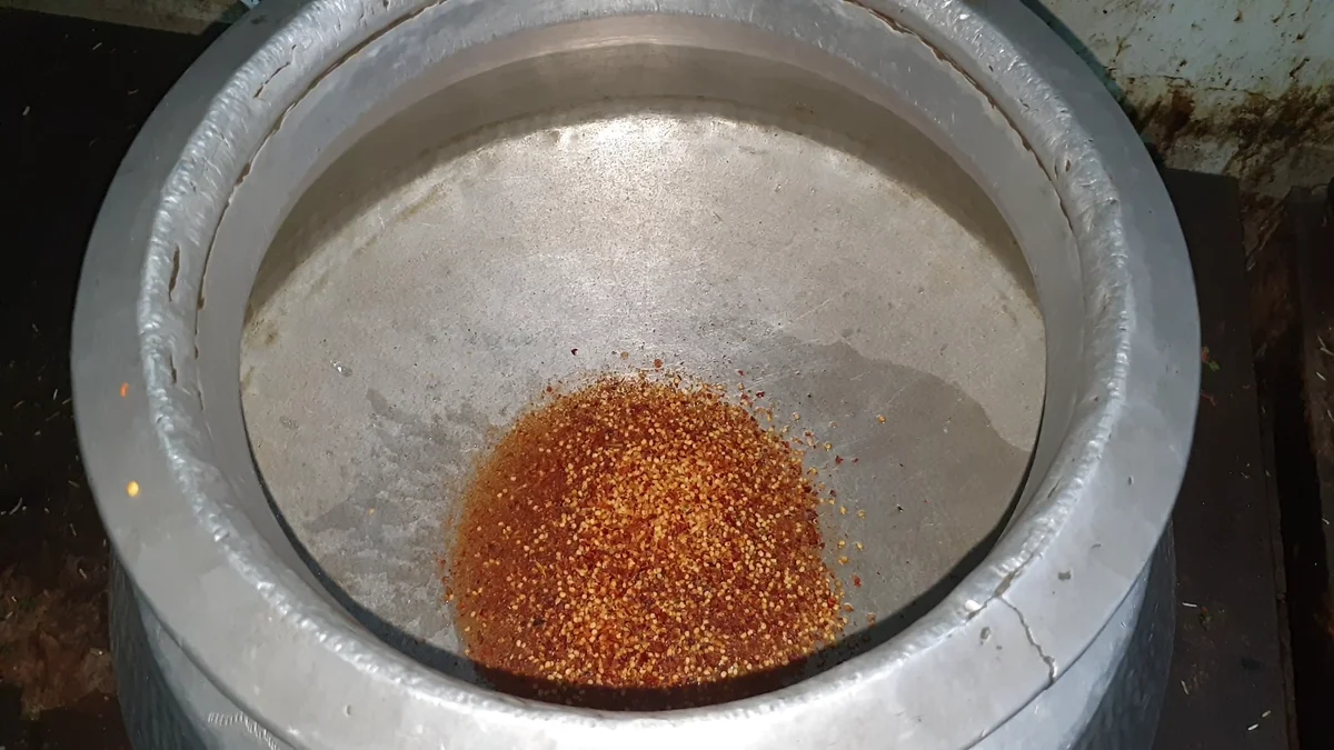 Spices frying in oil in the deg