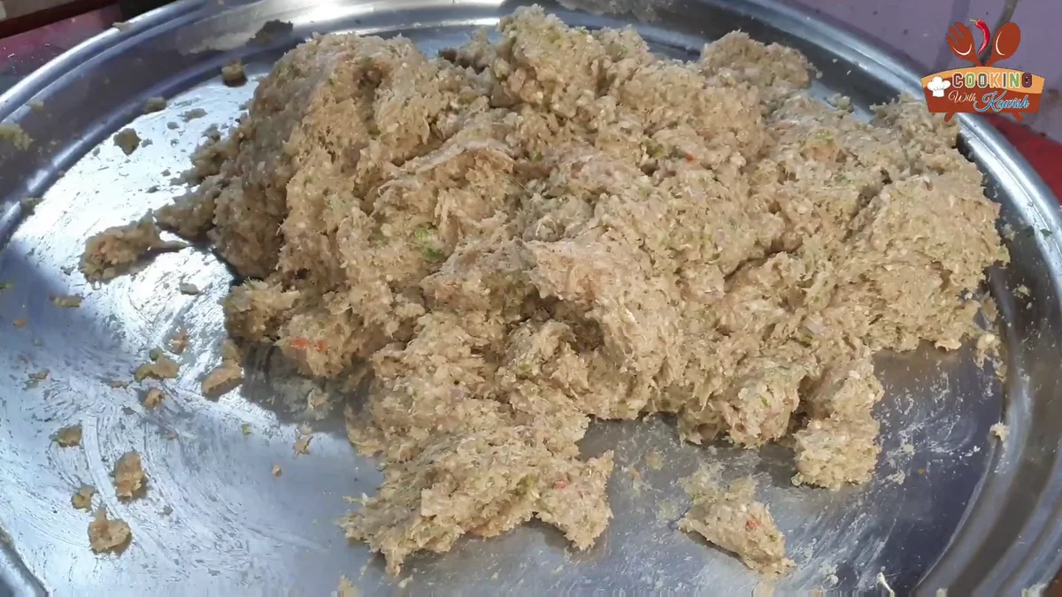 Fine ground chicken reshmi kabab mince in a steel tray